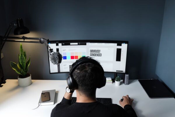 man in black shirt sitting in front of computer